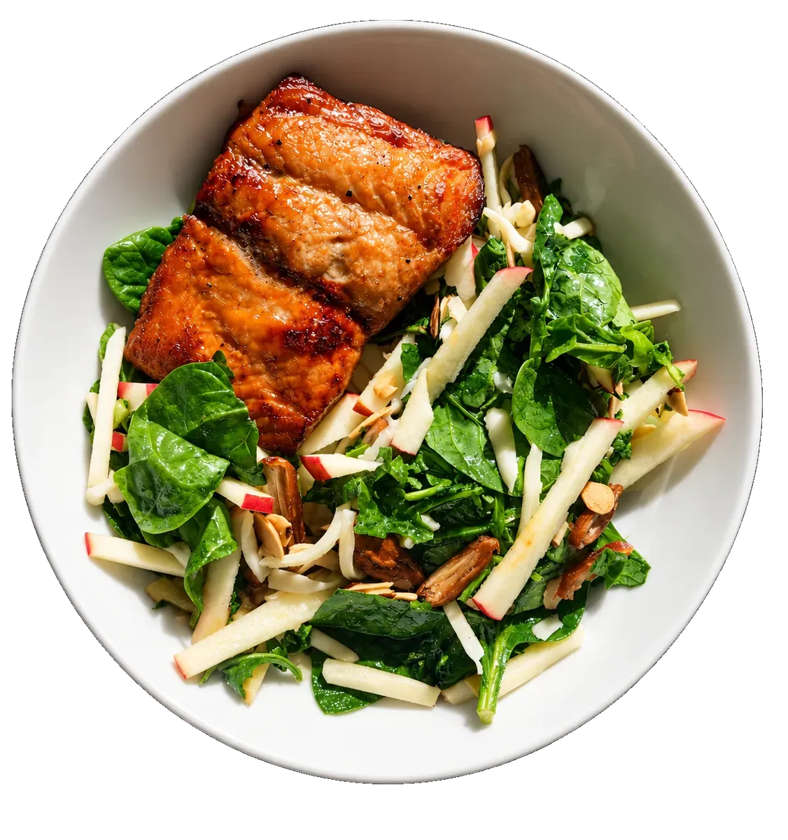 A bowl of glazed salmon on a green salad with apple matchsticks and almonds.